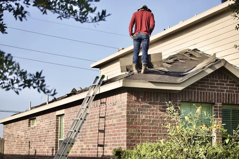 Professional roofer working on a residential roof in Canyon Country